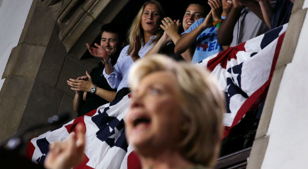 Students listen to U.S. Democratic presidential candidate Hillary Clinton as she speaks during a campaign event at Temple University .