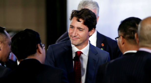 Canada's Prime Minister Justin Trudeau shakes hands with Chinese entrepreneurs in Beijing