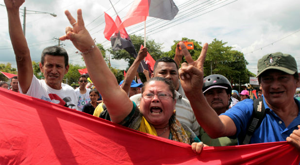 Supporters of Nicaragua's President Ortega block a street to members of a civil organization who protest against the upcoming presidential election in Masaya