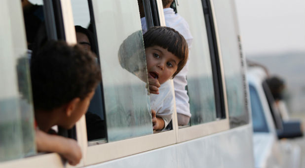 Displaced Iraqi children, who had fled to Syria to escape the violence in Mosul, transfer to a refugee camp in Kirkuk as they return to Iraq