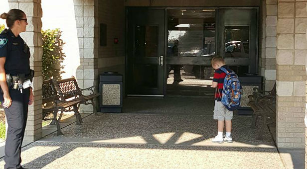 Royce Thompson stops to pray after the Pledge of Allegiance.