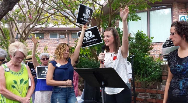 Natalie Brumfield prays outside a Planned Parenthood.