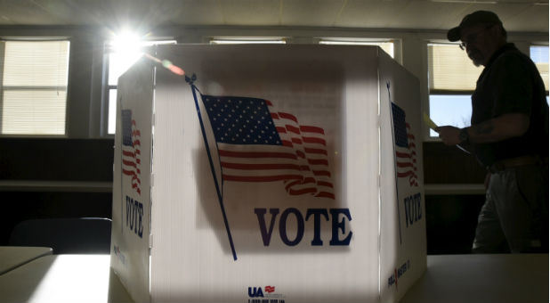 A voter heads to the booth to fill out his ballot at a polling site in Stillwater, Oklahoma.