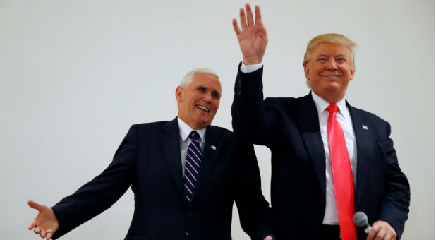 Republican presidential candidate Donald Trump and vice presidential candidate Mike Pence speak in an overflow room at a campaign event in Roanoke