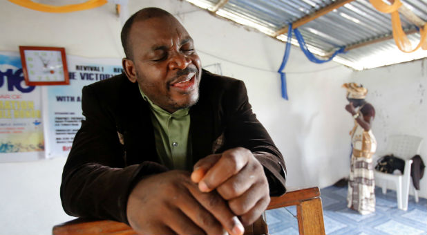 Evangelist and ex-combatant Joshua Milton Blahyi prays in a church in his hometown of Grand Gedeh, Liberia