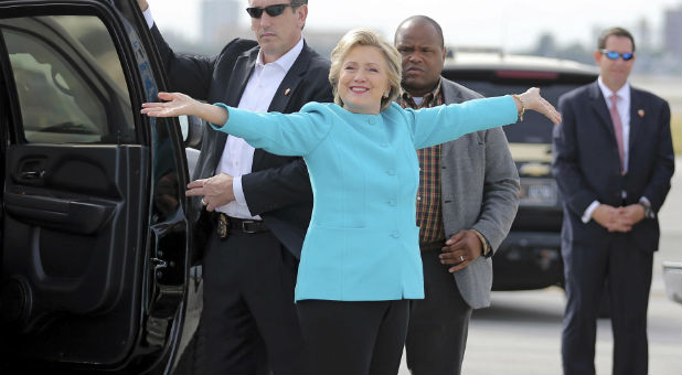 U.S. Democratic presidential candidate Hillary Clinton reacts before boarding her campaign plane at Miami international airport in Miami, Florida