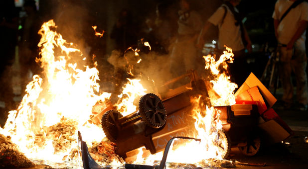 A pile of burning garbage set by demonstrators is seen on Broadway during a demonstration in Oakland, California, U.S. following the election of Donald Trump as President of the United States