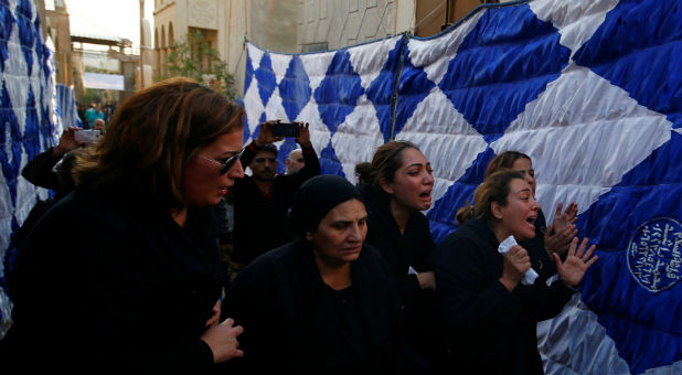 Egyptian Christians react during the funeral of victims killed in the bombing of Cairo's Coptic cathedral