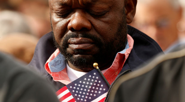 A man bows his head in prayer.