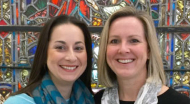 Co-pastors Maria Swearingen, left, and Sally Sarratt in front of the Burrall windows in the Palacios Chapel of Calvary Baptist Church in Dec. 2016.