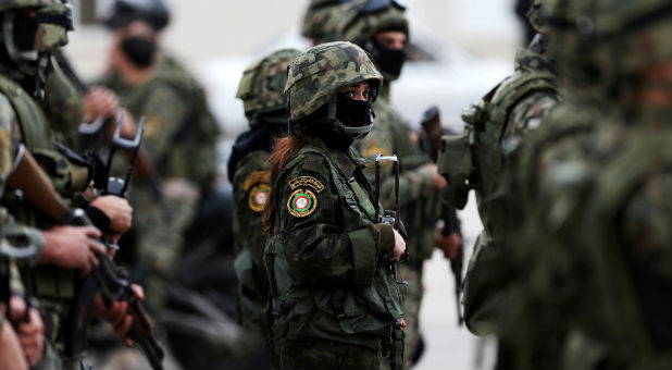 Female members of Palestinian National Security Forces take part in a graduation ceremony for young Palestinians who participated in a military training program, in the West Bank city of Jericho