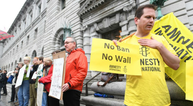 William Butkus joins about 12 protesters outside the 9th U.S. Circuit Court of Appeals courthouse in San Francisco, California February 7, 2017, after the Court heard arguments regarding President Donald Trump's temporary travel ban on people from seven Muslim-majority countries.