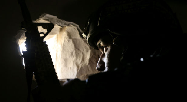 A member of Iraqi Counter-Terrorism Service (CTS) forces takes his position during a battle with Islamic State militants in Andalus neighborhood of Mosul