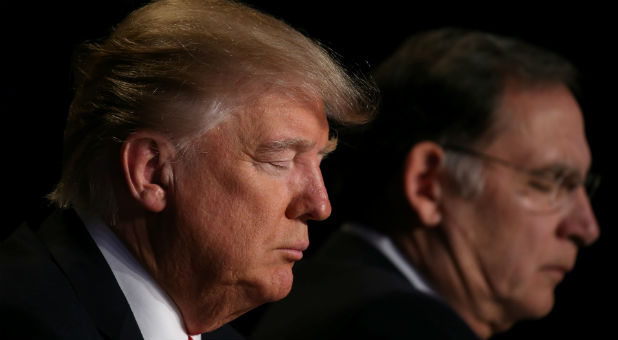 U.S. President Donald Trump prays during the National Prayer Breakfast event in Washington