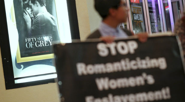 Tala Deloria protests against the film 'Fifty Shades of Grey' outside the Regency Bruin Theater in Los Angeles, California, Feb. 12, 2015. The small group of protesters claimed the film