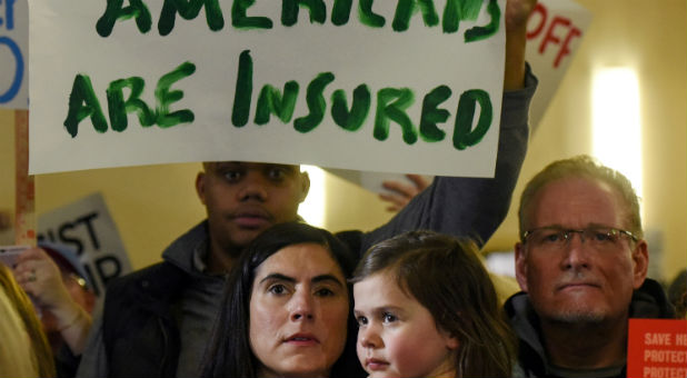 People demonstrate for the Affordable Care Act and against Trump