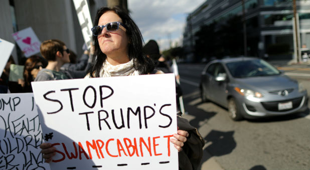 People protest against President Donald Trump's Cabinet picks