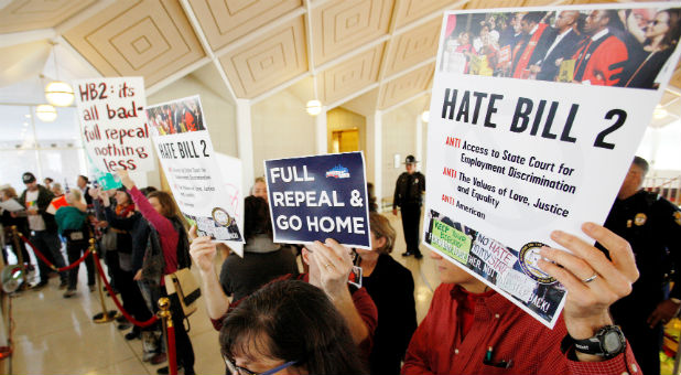 Opponents of North Carolina's HB2 law limiting bathroom access for transgender people protest in the gallery above the state's House of Representatives chamber as the legislature considers repealing the controversial law