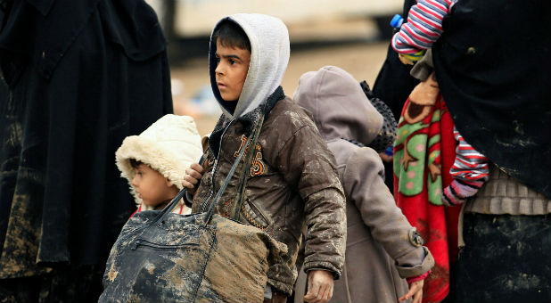 Displaced Iraqi children who fled their homes with their family during a battle between Iraqi forces and Islamic State militants, gather at a checkpoint to be transferred to Hammam al-Alil camp, in Mosul