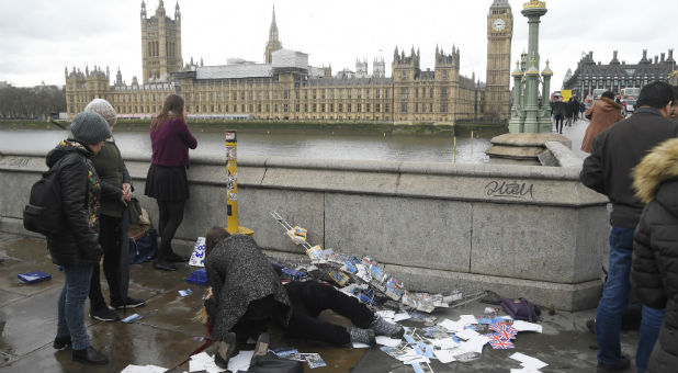 An injured woman is assisted after an incident on Westminster Bridge in London.