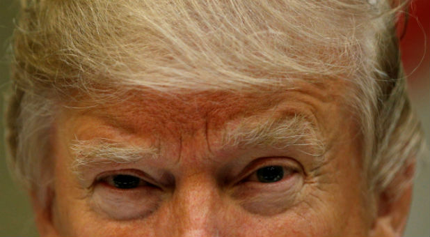 U.S. President Donald Trump looks up while hosting a House and Senate leadership lunch at the White House