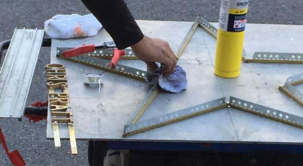 A worker prepares Chris Pratt's star on the Hollywood walk of fame.