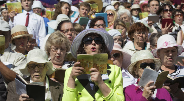 Jehovah's Witnesses pray during a regional congress of Jehovah's Witnesses at Traktar Stadium in Minsk, Belarus