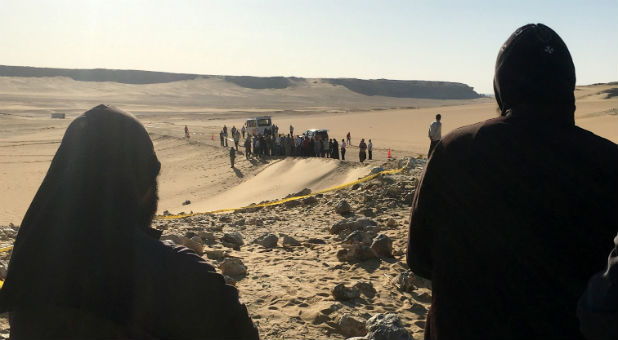 Monks look at the view following a gunmen attack against a group of Coptic Christians travelling to a monastery in southern Egypt, in Minya.