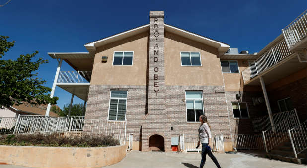 Briell Decker, the 65th wife of jailed Fundamentalist Church of Jesus Christ of Latter-Day Saints (FLDS Church) polygamist prophet leader Warren Jeffs, walks past an outdoor chimney marked with