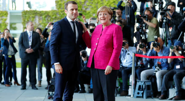 German Chancellor Angela Merkel and French President Emmanuel Macron arrive at a ceremony at the Chancellery in Berlin, Germany, May 15, 2017.