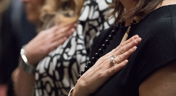 Women recite the Pledge of Allegiance.