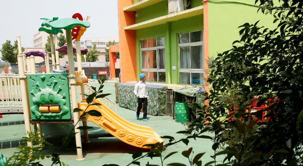 An investigator walks at the scene of an explosion inside a kindergarten in Fengxian County of Xuzhou in Jiangsu Province, China.