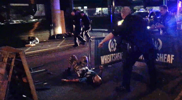 An image taken from video shows three men on the ground after they were shot by police in Borough Market during an attack on London Bridge and the market, in London.