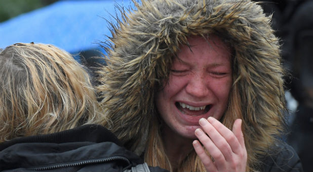 A woman reacts near the scene of the recent attack during a minute's silence in tribute to the victims of the attack at London Bridge and Borough Market, in central London.