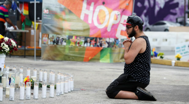 Jose Ramirez, a survivor of the Pulse nightclub shooting, reacts at the memorial outside the club on the one-year anniversary of the shooting, in Orlando, Florida.