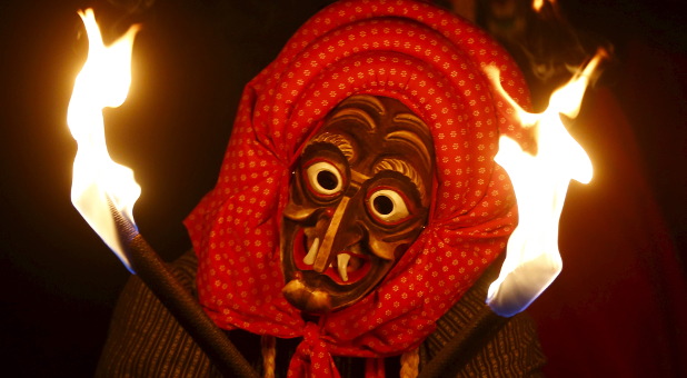 A traditional witch participates in a ritual.