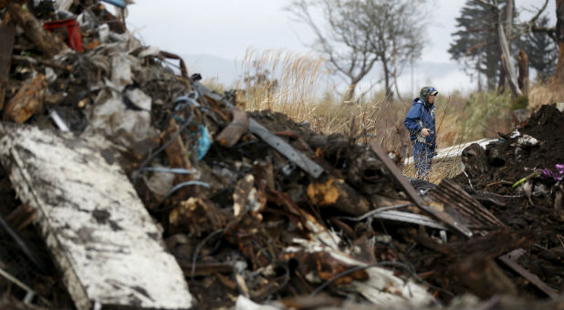 Takayuki Ueno, 43, who lost his parents, daughter and son in the March 11, 2011 tsunami, searches for missing people inside the exclusion zone in Okuma, near Tokyo Electric Power Co's (TEPCO) tsunami-crippled Fukushima Daiichi nuclear power plant, Fukushima Prefecture, Japan, February 14, 2016.