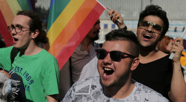 LGBT rights activists shout slogans as they try to gather for a pride parade.