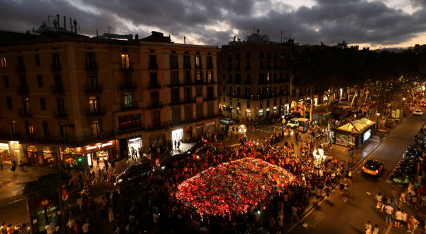 People gather at an impromptu memorial where a van crashed into pedestrians at Las Ramblas in Barcelona, Spain, Aug. 20, 2017.