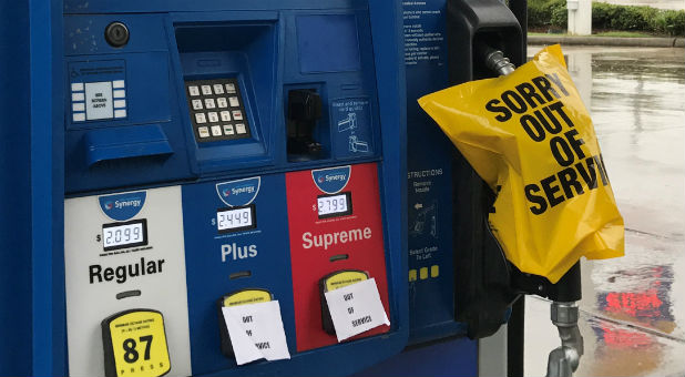 A gas pump is covered with an out-of-service message as fuel ran out ahead of Hurricane Harvey's arrival near the Texas coastal area, in Houston, Texas.