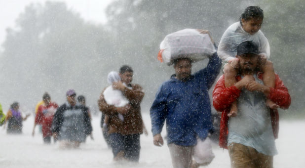 Residents wade through floodwaters from Tropical Storm Harvey in Beaumont Place, Houston, Texas, U.S., on Aug. 28, 2017.