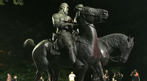 Workers remove the monuments to Robert E. Lee, commander of the pro-slavery Confederate army in the American Civil War, and Thomas