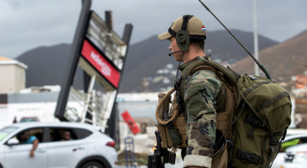 A soldier evaluates damage in Sint Maarten.