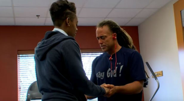 Todd White prays for someone at the gym.