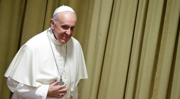 Pope Francis arrives to deliver a speech.