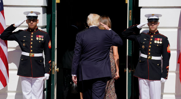 U.S. President Donald Trump salutes marines.