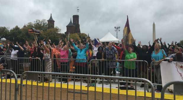 Women worship on the National Mall.