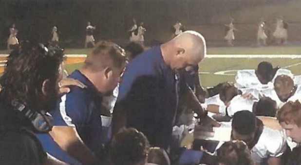 Heaven help the coach who bows his head to pray in Coweta County, Georgia.