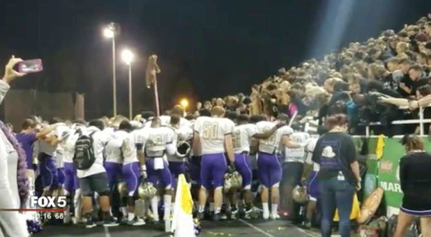 Students pray at a Georgia high school.