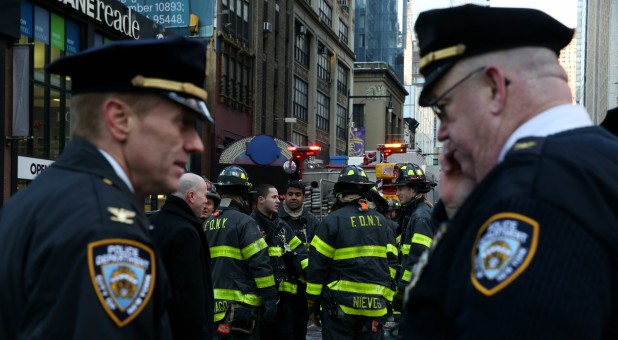 New York Police Department (NYPD) officers stand guard near Port Authority Bus Terminal after reports of an explosion in Manhattan, New York.